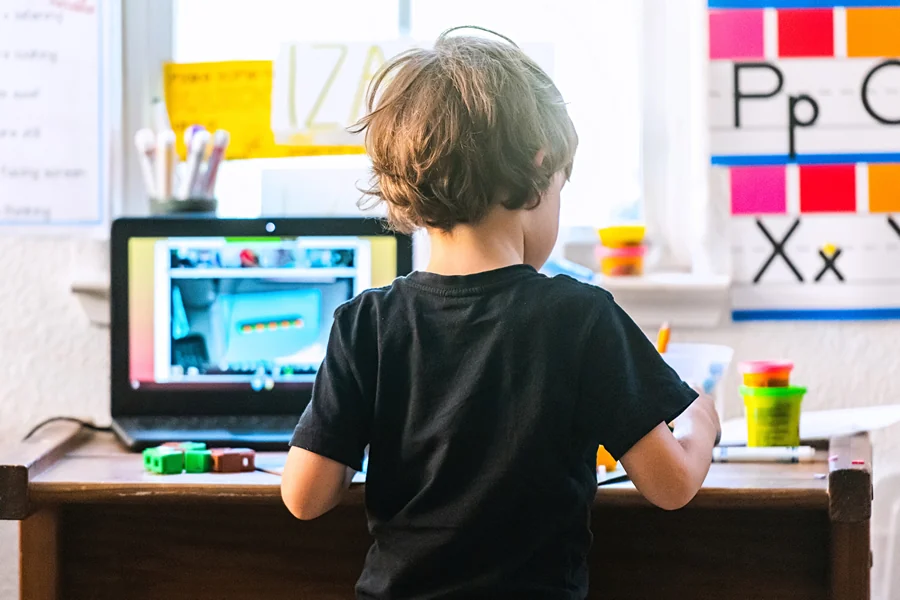 Child working at a laptop during a hands-on learning activity